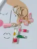 Suministros del Fabricante Llaveros con Flores Secas Prensadas 26 Letras del Alfabeto Inglés Llaveros con Borla de Mariposa Charms para Bolsos de Mujer