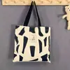 En stock Bolsa de Lona de Dibujos Animados para Llevar en la Mano un Solo Hombro Estudiante Tutores Literatura Versátil Cuatro Estaciones Portátil Bolsa de Tela Bolsa de Viaje para Mujer