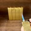 Comercio exterior transfronterizo nuevo creativo papel de regalo lingote de oro carcasa de hierro suministro en stock oblicuo inflable recto encendedor a prueba de viento