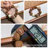 El fabricante suministra una colección de pulseras de hueso de durazno naturales, pulseras de hueso de durazno de círculo único para hombres y mujeres, populares en Xiaohongshu, con diseño de agujero pasante