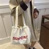Bolsa de Lona 2026 Modelo Nuevo Gran Capacidad Bolso de Hombro para Mujer Bolso Tote Estilo Coreano Literario Versátil Casual Bolsa Perezosa Venta al por Mayor