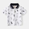 Ropa Infantil de Moda Tops 2026 Verano Estilo Coreano Serie de Dinosaurios para Niños Camisas Polo de Manga Corta Camisetas para Bebé Venta al por Mayor
