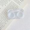 Caja de lentes de contacto transparente con un lindo y pequeño macarrón integrado para guardar lentes de contacto en pareja.
