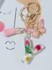 Suministros del Fabricante Llaveros con Flores Secas Prensadas 26 Letras del Alfabeto Inglés Llaveros con Borla de Mariposa Charms para Bolsos de Mujer