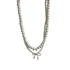 Collar de doble capa con cuentas, lazo y circonita de perla, cadena para la clavícula de temperamento elegante francés, joyería de lujo ligero de alta gama para mujer