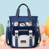Linda bolsa de tutoría de dibujos animados para niñas de primaria, bolso de mano y bandolera de gran capacidad, bolsa impermeable y resistente al desgaste para libros de arte