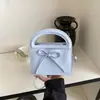Bolsa de mão simples com laço transfronteiriça para mulheres, nova bolsa elegante e versátil de alta qualidade para ombro e transversal 2026