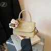 Bolsa Quadrada Pequena de Mola Estilo Hong Kong Ombro Único 2026 Nova Tendência Design de Nicho Moda Cor Sólida Bolsa Transversal de Alta Qualidade
