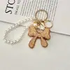 Chaveiro Laço Cheio de Diamantes Crystal Light Luxo Completo Sensação de Alto Padrão Pingente de Bolsa com Corrente de Pérola Tendência da Moda Pingente de Strass