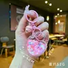 Chaveiro de Acrílico Brilha no Escuro Pirulito Rosa Doce Morango Areia Líquida Criativa Pingente Charme para Bolsa Atacado