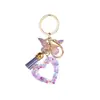 Llavero de Resina con Lentejuelas en Forma de Corazón Transfronterizo Lindo Corazón de Amor Borla de Mariposa Colgante de Bolso de Moda para Mujer Venta al por Mayor