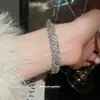 Pulseira Redonda Europeia e Americana Transfronteiriça com Borla e Cravejada de Diamantes, Pulseira Minimalista Moderna de Estilo Nicho com Design Único, Joia de Mão de Nicho