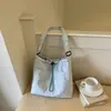 Bolsa de lona simple estilo coreano con cordón, bolso cruzado suave y versátil para las salidas diarias de las estudiantes universitarias, ofreciendo una sensación relajada.