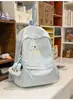 Mochila bordada com filhote de cachorro pintado em azul névoa e branco leitoso para estudantes, adequada para meninas, leve e versátil para o trajeto diário.