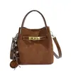 Bolso pequeño de mano con acabado mate texturizado para mujer, nuevo bolso tipo cubo retro otoño/invierno 2026, bolso de hombro/cruzado elegante y versátil