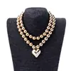 Collar de Metal Vintage Dorado Redondo de Doble Capa Transfronterizo con Colgante de Corazón Brillante, Cadena para Clavícula de Gama Alta de Nicho