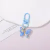 Chaveiro de resina borboleta cor de doce, estilo fofo e doce, pingente feminino, fornecimento para barracas de rua e feiras noturnas, atacado de acessórios de alta qualidade