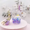 Perro blanco pequeño azul flotando en aceite, figura de cachorro en una botella de arena líquida, llavero de muñeca de dibujos animados lindo, regalo