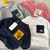 Camiseta de Manga Larga T2026 Ojos Bizcos Color Nuevo de Primavera Bloque de Color Bolsillo Manga Larga para Niños y Niñas Camiseta con Letra para Bebé