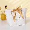 Bolsa de papel portátil ins bow al por mayor bolsa de regalo de Año Nuevo bolsa pequeña para cosméticos bolsa para ropa logotipo imprimible