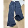 Estilo moderno de calle, corte diagonal y diseño patchwork, pantalones casuales ligeramente acampanados para hombre, nueva colección primavera/otoño, corte ajustado, pantalones largos de pierna recta