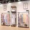 Perchero moderno simple de piso estante multicapa simple estante para ropa de mujer soporte de exhibición de ropa de hierro venta al por mayor