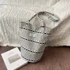 Bolsa estampada de nicho súper popular para mujer, nuevo modelo 2026, casual y versátil para el trabajo, bolso de hombro, tote, bolso cubo, bolsa de tela