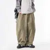 Pantalones de trabajo de mezclilla lavada estilo retro americano, unisex, con un diseño minimalista, corte holgado y estilo de pierna ancha