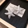 Brincos de Tarraxa Estrela do Mar Sol Cruzado Europeu e Americano Estilo Cool Personalidade Brincos de Temperamento Luxo Leve Sensação de Alto Padrão Joias para Orelha Atacado