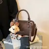 Bolsa de Almofada Texturizada de Nicho de Luxo para Mulheres, Novo Modelo de Comércio Exterior, Bolsa de Ombro Cruzada Única, Bolsa Boston, Bolsa de Mão Pequena para Mulheres