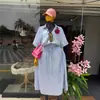 Ropa Femenina Transfronteriza Europea y Americana 2026 Verano Nueva Moda Conjunto de Camisa Azul a Rayas Holgada y Falda con Cintura de Corbata