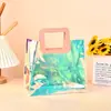 Bolsa de mano tipo tote con láser de PVC sentido avanzado bolsa de regalo para la mano estilo ins bolsa mágica de gelatina bolsa de regalo de plástico transparente personalizada