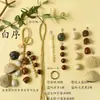Kit de material DIY para fazer um móbile de casca de fruta, um sino pendurado de cura, com frutas pretas indonésias, estramônio, lírio d'água e rotim