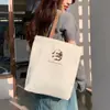 Bolsa de Lona para Mulheres 2025 Nova Estudante Grande Capacidade Bolsa de Mão Estilo Literário Preppy Bolsa Tiracolo Simples Bolsa de Ombro Estampada