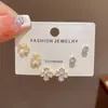 Conjunto de brincos requintado e moderno estilo japonês e coreano, com zircônia cúbica em formato de trevo de quatro folhas e pedra olho de gato, perfeito para uso diário e para ir ao trabalho, apresentando um design pequeno e simples