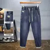 Novas calças casuais de outono e inverno, cintura elástica moderna, forradas com fleece, jeans espessado, calças masculinas soltas stretch slim-fit
