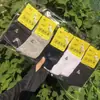 26 modelos de otoño e invierno al por mayor: Calcetines deportivos de algodón de media pantorrilla para otoño e invierno, calcetines versátiles para hombres y mujeres