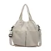 Nova bolsa de tecido de comércio exterior, bolsa de mão versátil de cor sólida simples estilo japonês, bolsa de ombro e transversal casual de grande capacidade para o dia a dia, moderna
