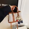 Bolso de cubo portátil de moda de alta gama para mujer 2025 primavera nuevo bolso tote de lona versátil popular bolso bandolera