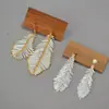 Diseño de Nicho Europeo y Americano Pluma Blanca Simple Cuentas Antiguas Tejidos a Mano Elegantes con Estilo Pendientes de Gama Alta Pendientes
