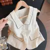 Camisa sem mangas de rami 2026 Novo estilo de verão Gola lapela vintage Blusa Feminina Decoração de bolso Cor sólida Colete