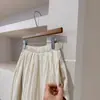 Adaptabilidad desde el Color Beige Diseño Suave, Falda de Retazos de Cintura Alta de Longitud Media Texturizada E018