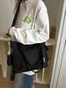 Nuevo bolso de lona para mujer de principios de otoño de 2026, bolso tote versátil para el trabajo, bolso de hombro de gran capacidad para la escuela, bolsos de mujer al por mayor