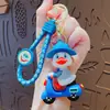 Chaveiro Criativo de Desenho Animado Pato Pequeno Andando de Bicicleta Elétrica Pingente para Bolsa de Casal Chaveiro de Carro Presente Venda por Atacado