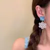 Pendientes de flor azul estilo vacación de verano en la playa, diseño exquisito y único, pendientes versátiles que adelgazan el rostro