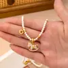 Nuevo Estilo "Caballo de Dinero" Collar de Perlas Shijia, Moda de Lujo Ligero, Diseño de Nicho, Sensación de Alta Gama, Cadena Versátil para Suéter