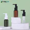 Botella dispensadora portátil de 50 ml de PET para loción de aceite desmaquillante con cabezal de bomba, botella para tónico, material de empaque de belleza, en stock, venta directa de fábrica