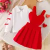 Conjunto de dos piezas para bebé niña estilo europeo y americano, para primavera y otoño, nuevo, con estampado de corazones rojos, falda con tirantes y polo de manga larga, elegante y a la moda, en stock
