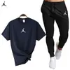 Traje deportivo informal de verano con camiseta y pantalones de algodón de manga corta y cuello redondo para hombre, disponible en stock.