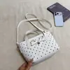 Bolsas de lunares de nicho de verano para mujer 2026 Nueva moda Bolsos cruzados versátiles Bolsos de cubo de mano exquisitos Bolsos de mano pequeños